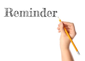 Woman writing word REMINDER on white background, closeup