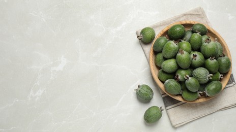 Fresh green feijoa fruits on light grey marble table, flat lay with space for text. Banner design