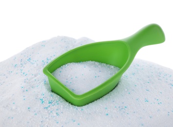 Measuring scoop with laundry powder on white background