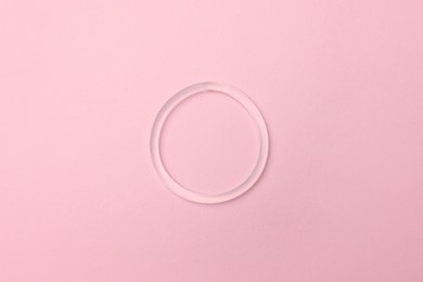 Photo of Diaphragm vaginal contraceptive ring on pink background, top view