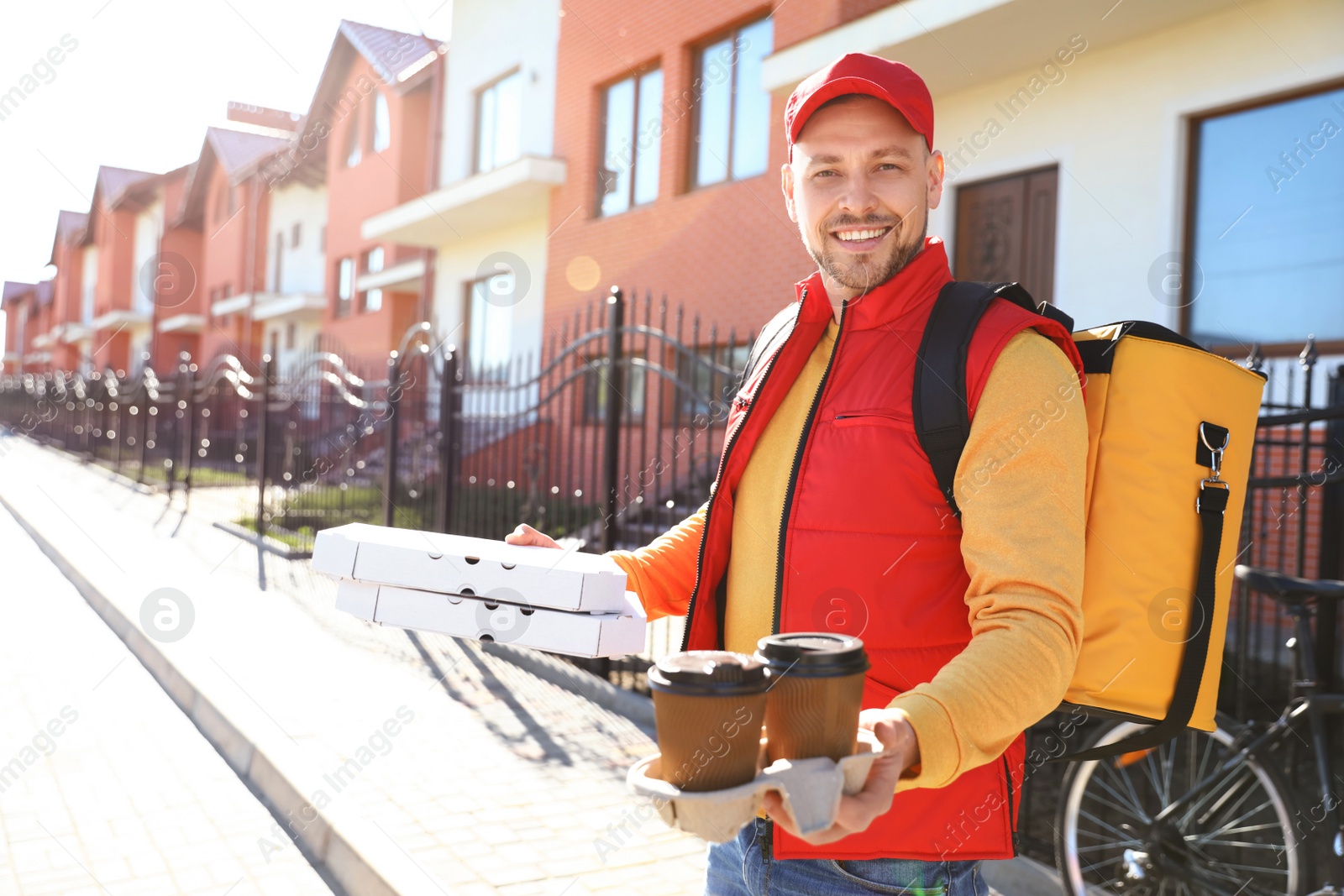 Photo of Male courier delivering food in city on sunny day