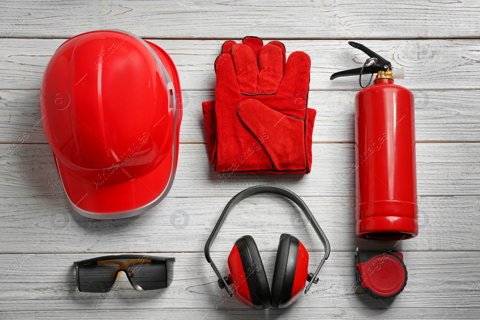 Photo of Flat lay composition with safety equipment on wooden background