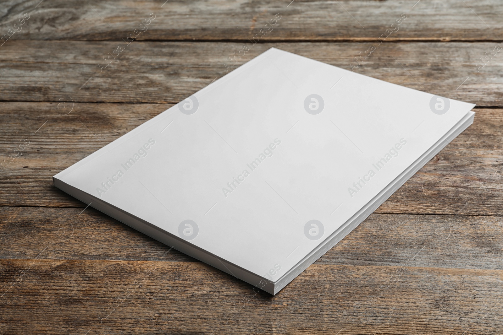 Photo of Brochure with blank cover on wooden background. Mock up for design