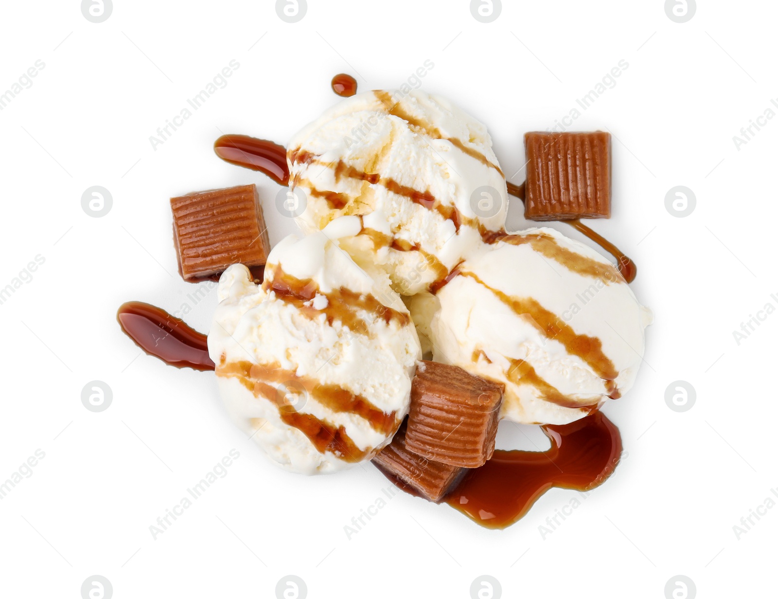 Photo of Scoops of ice cream with caramel sauce and candies isolated on white, top view