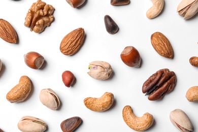 Composition with organic mixed nuts on white background, top view