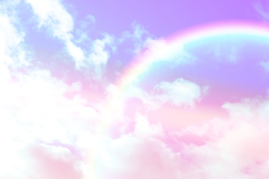 Image of Amazing sky with rainbow and fluffy clouds, toned in unicorn colors