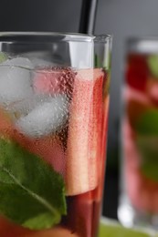 Glass of tasty rhubarb cocktail with lime, closeup