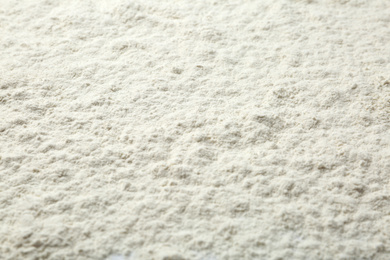 Photo of Pile of organic flour as background, closeup