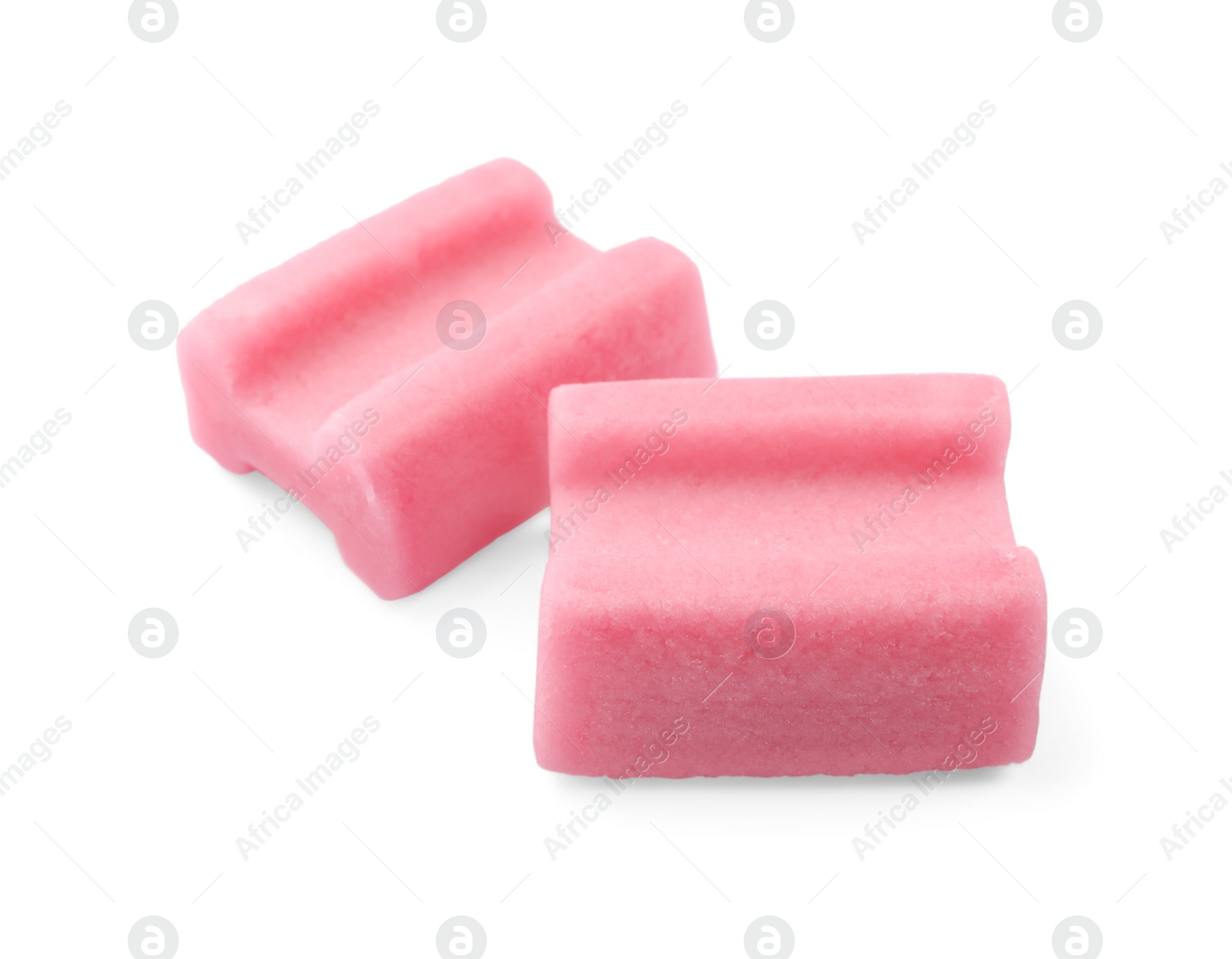 Photo of Tasty pink chewing gums on white background