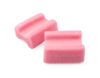 Photo of Tasty pink chewing gums on white background