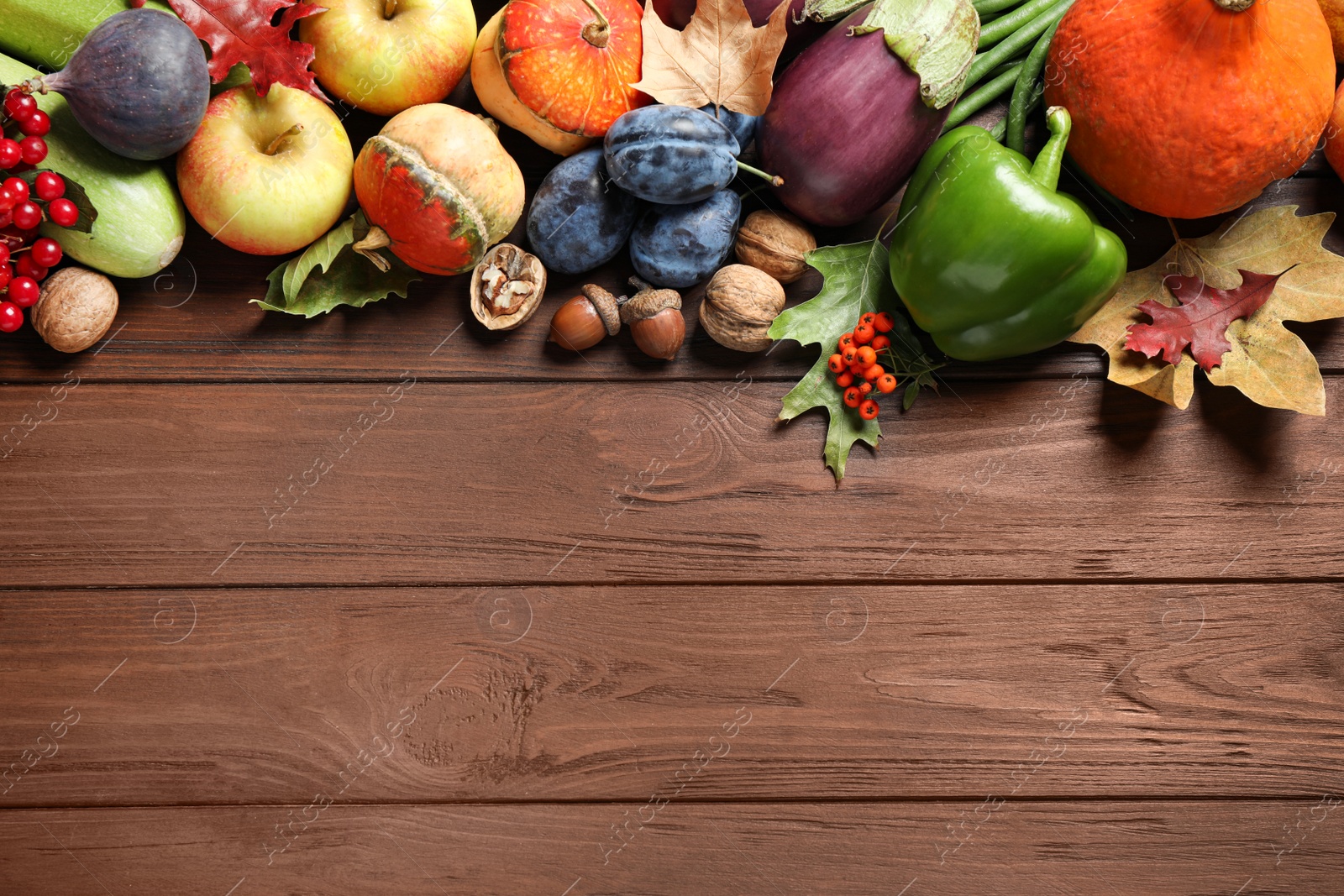 Photo of Flat lay composition with autumn vegetables and fruits on wooden background, space for text. Happy Thanksgiving day