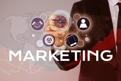 Image of Marketing concept. Businessman pointing at target on digital screen with icons, graphs and world map, closeup