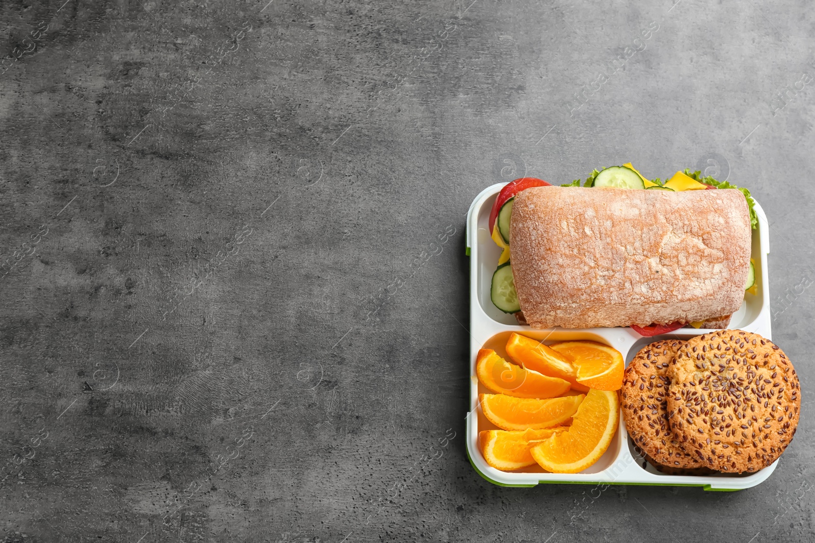 Photo of Lunch box with appetizing food on grey background, top view