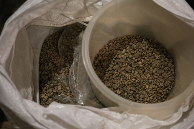 Photo of Raw coffee beans in sack, above view