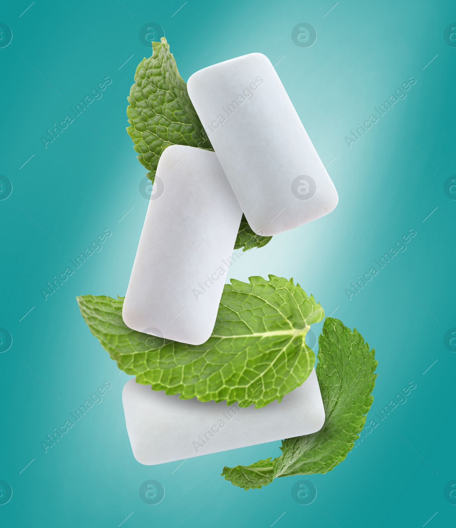 Image of Fresh mint leaves and chewing gum pads falling on turquoise background