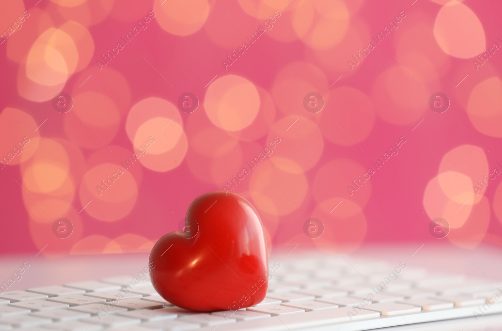 Photo of Red decorative heart on computer keyboard. Online dating