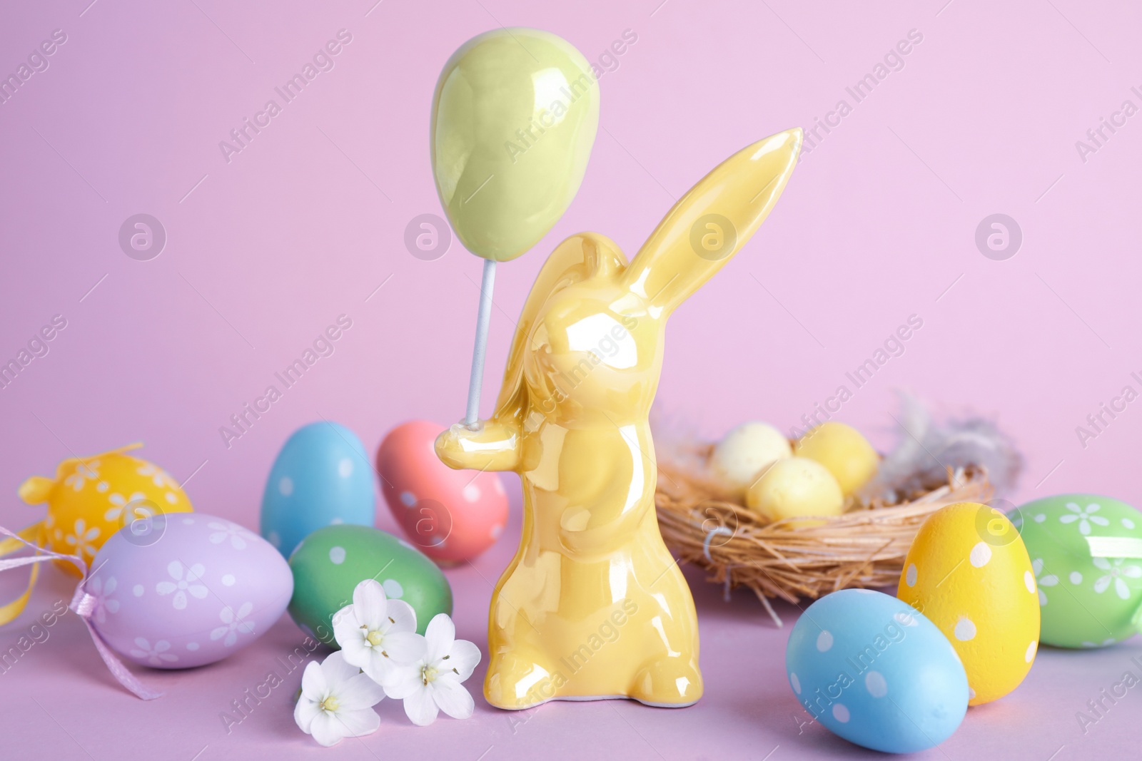 Photo of Composition with Easter bunny figure on violet background