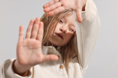 Photo of Fashion concept. Stylish girl posing on light grey background