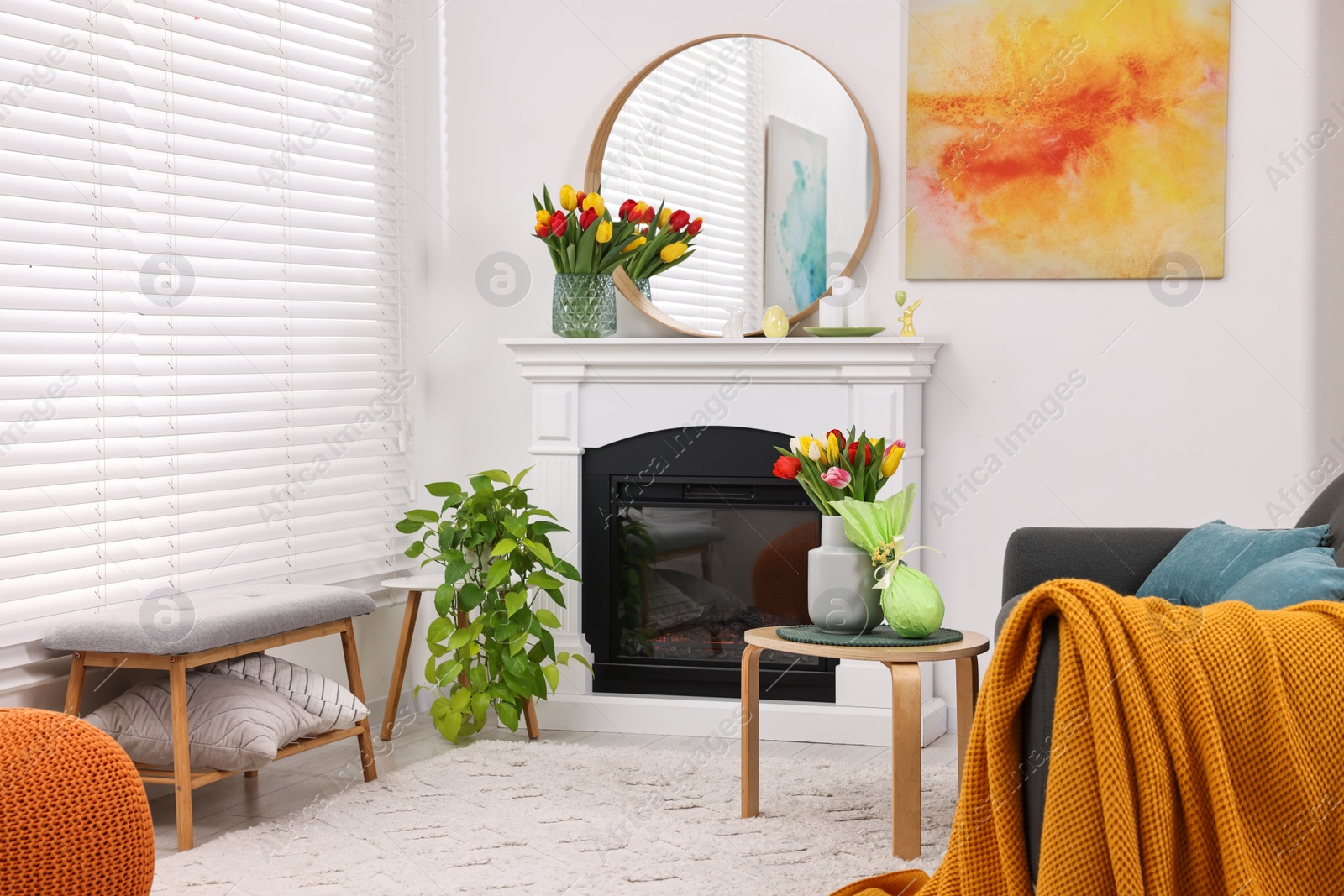 Photo of Beautiful Easter decorations and furniture in stylish room