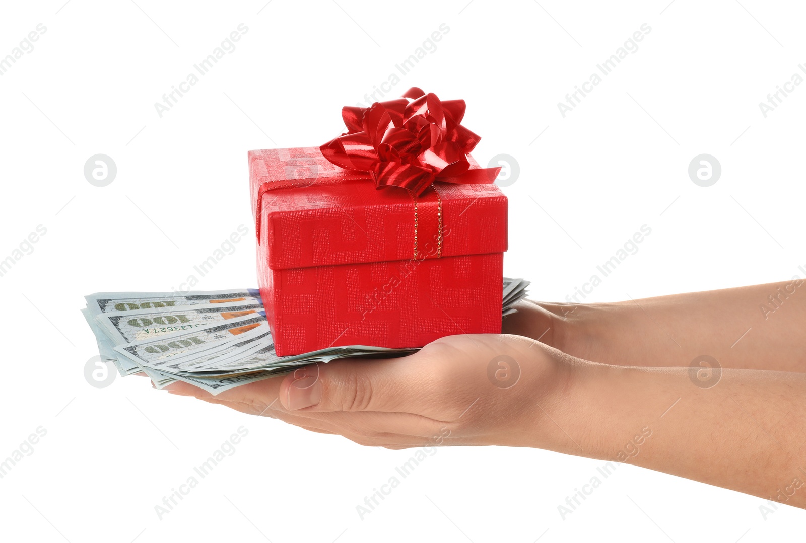 Photo of Woman holding gift box and dollar banknotes on white background, closeup