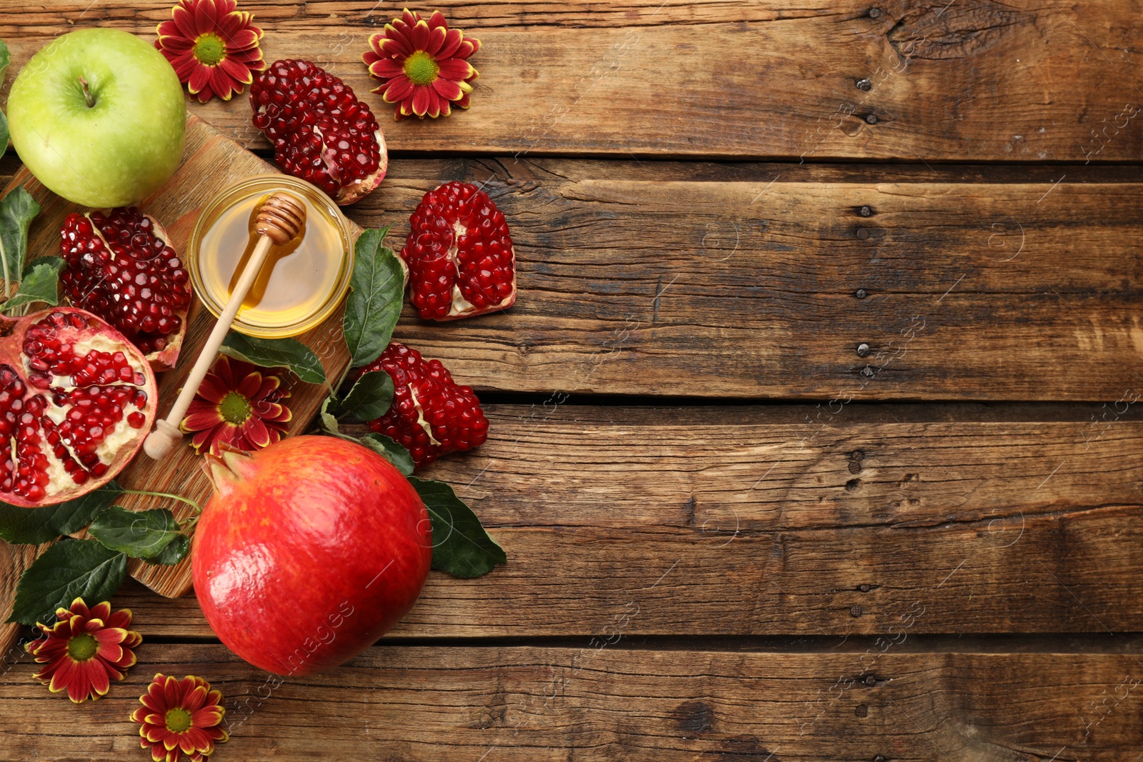 Photo of Flat lay composition with Rosh Hashanah holiday attributes on wooden table. Space for text