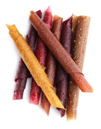 Photo of Delicious fruit leather rolls on white background, top view