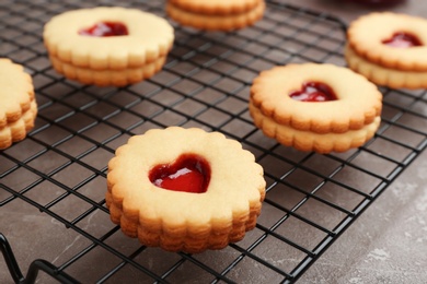 Traditional Christmas Linzer cookies with sweet jam on cooling rack