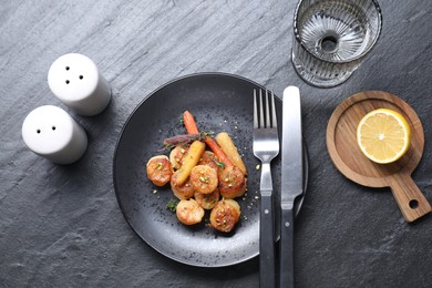 Delicious fried scallops served on dark gray textured table, flat lay