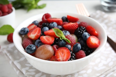 Photo of Fresh tasty fruit salad on table, closeup