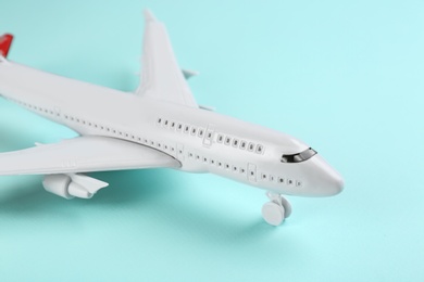 Photo of Toy airplane on light blue background, closeup