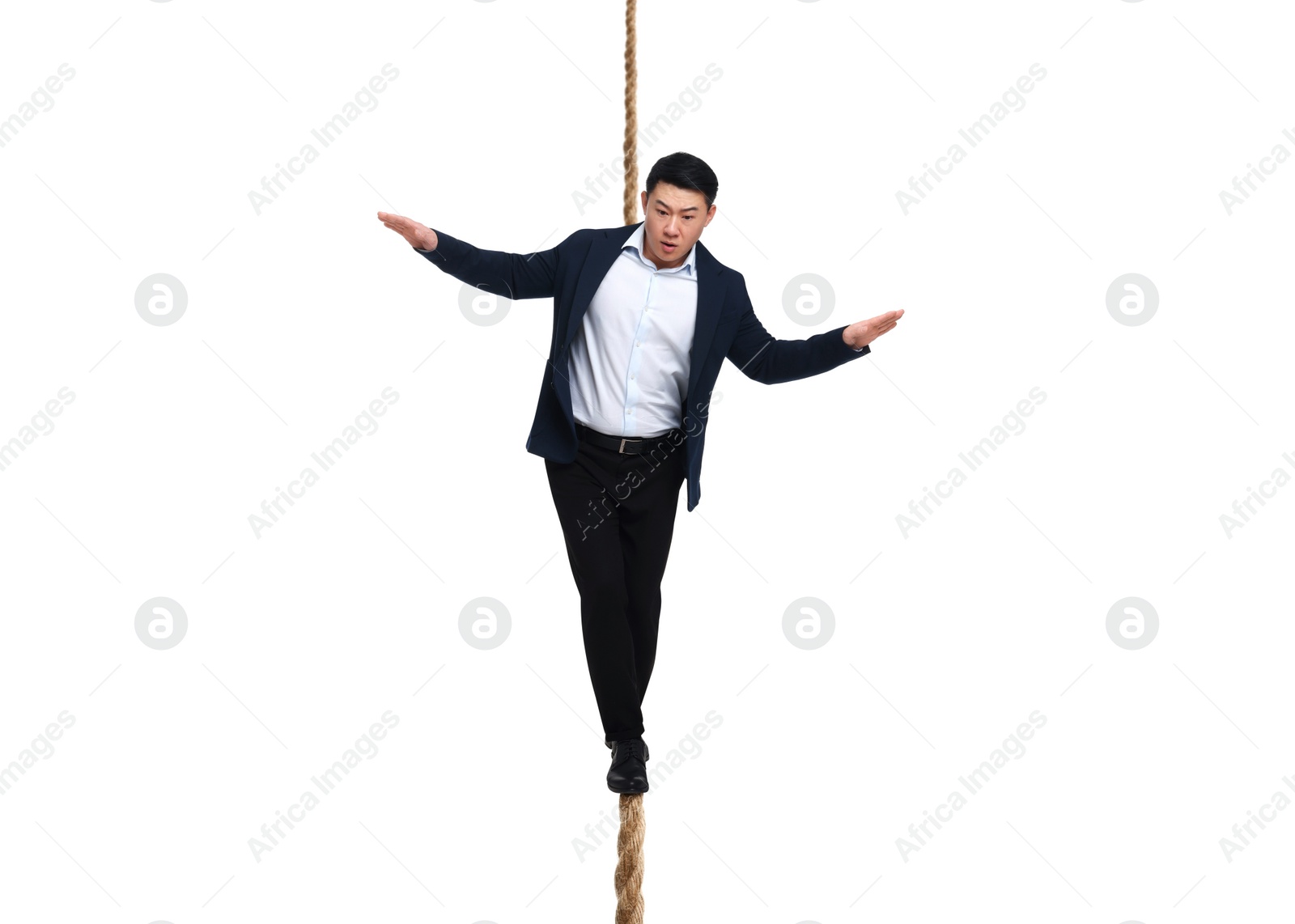 Image of Risks and challenges of owning business. Man balancing on rope against white background