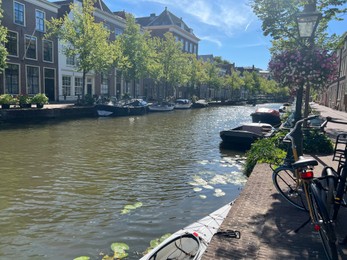 Photo of Leiden, Netherlands - August 03, 2022: View of city street with buildings along canal