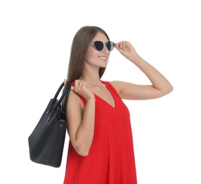 Young woman wearing stylish red dress with elegant bag on white background