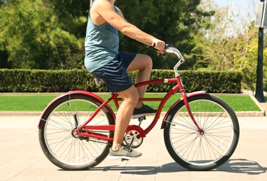 Photo of Man riding bike outdoors on sunny day