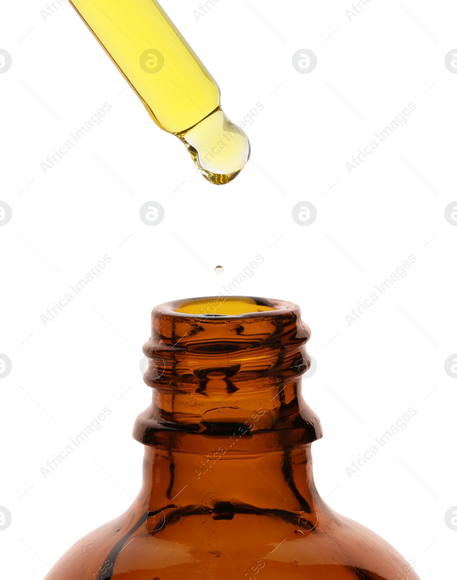 Photo of Dripping tincture from pipette into bottle isolated on white