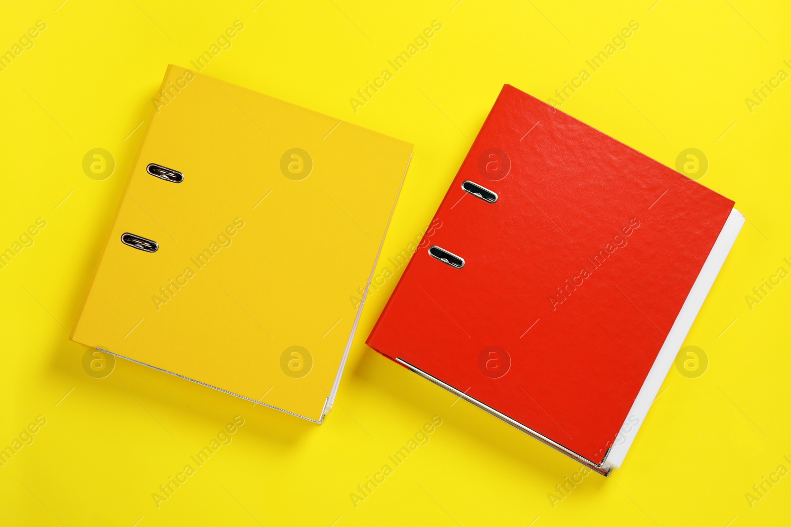 Photo of Office folders on yellow background, flat lay