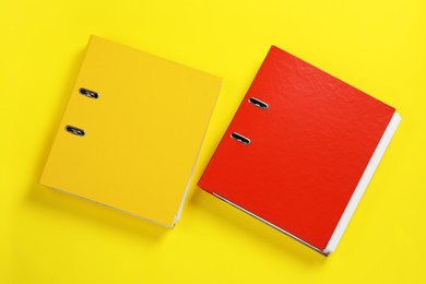 Photo of Office folders on yellow background, flat lay