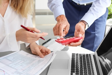 Tax accountants working with documents at table