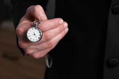 Man holding chain with elegant pocket watch, closeup