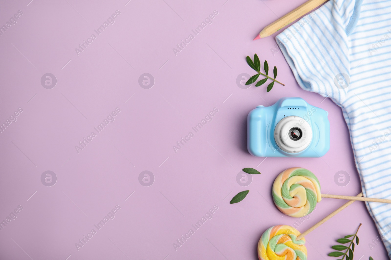 Photo of Flat lay composition with toy camera on violet background, space for text. Future photographer