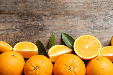 Photo of Flat lay composition with ripe oranges and space for text on wooden background