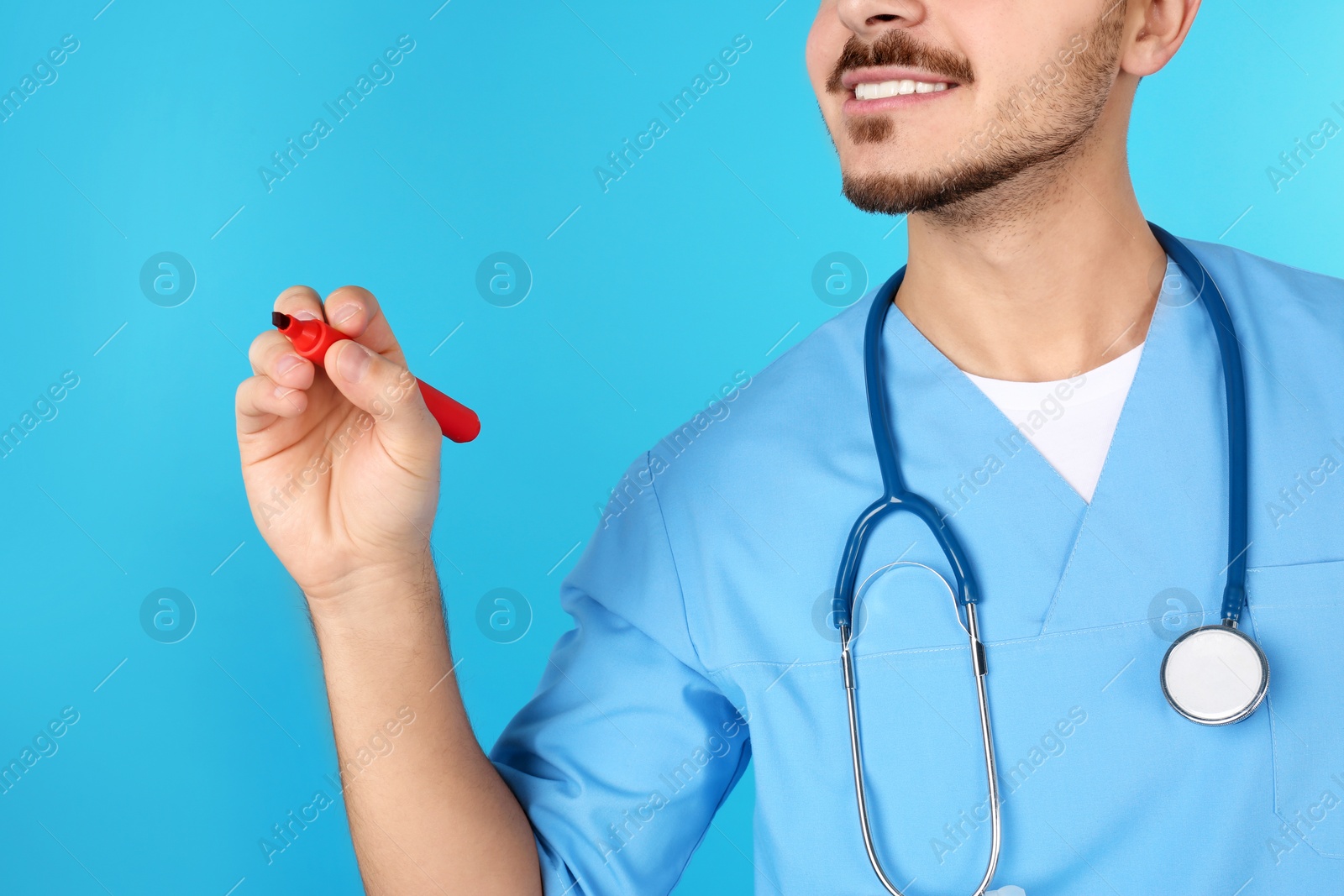 Photo of Medical student with marker on color background, closeup