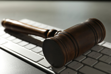 Photo of Gavel and computer keyboard on grey table. Cyber crime