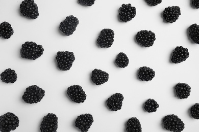 Flat lay composition with ripe blackberries on white background