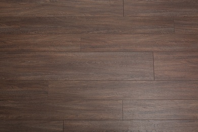 Clean wooden laminate as background, top view. Floor covering