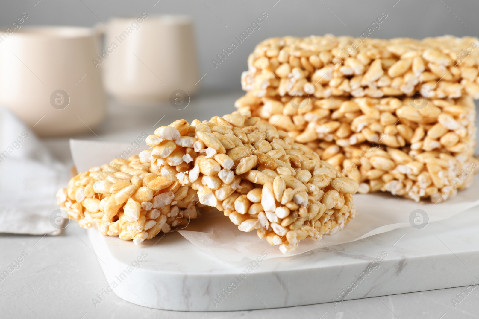 Photo of Delicious rice crispy treats on light grey table