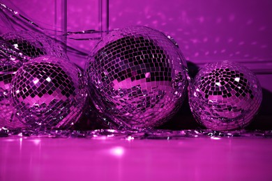 Photo of Shiny disco balls indoors, toned in purple