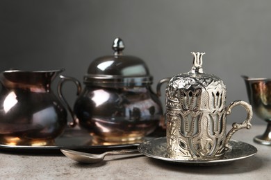 Photo of Vintage tea set on grey table. Space for text