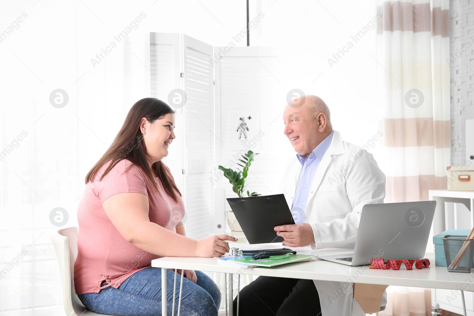 Photo of Overweight woman having consultation at doctor's office