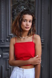 Photo of Portrait of beautiful young woman near vintage door outdoors
